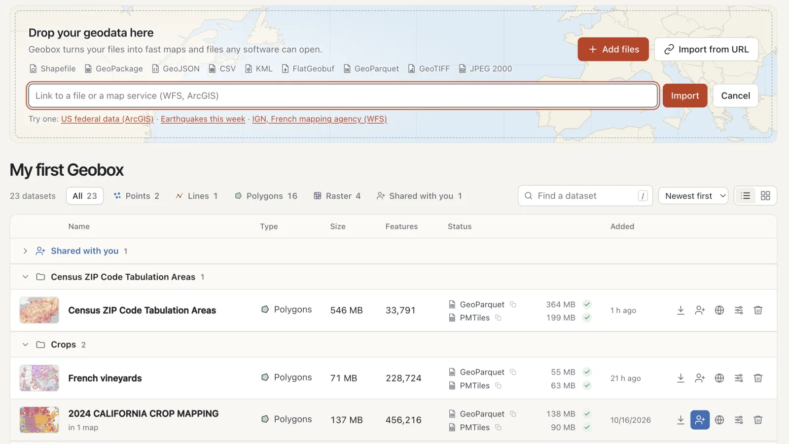 The Geobox home: a drop zone for files or a link to a map service, and datasets grouped by theme, each with its GeoParquet and PMTiles files